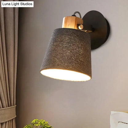 Gray fabric wood accent wall lamp with wooden top and black wall mount, warm light on Tampa Home & Garden Store