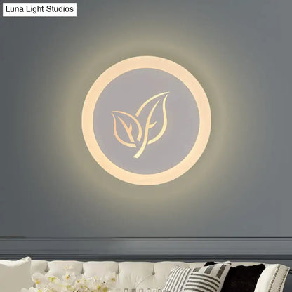 White acrylic leaf wall lamp by Decorbites, circular wall light with leaf motif, warm glow on Tampa Home & Garden Store