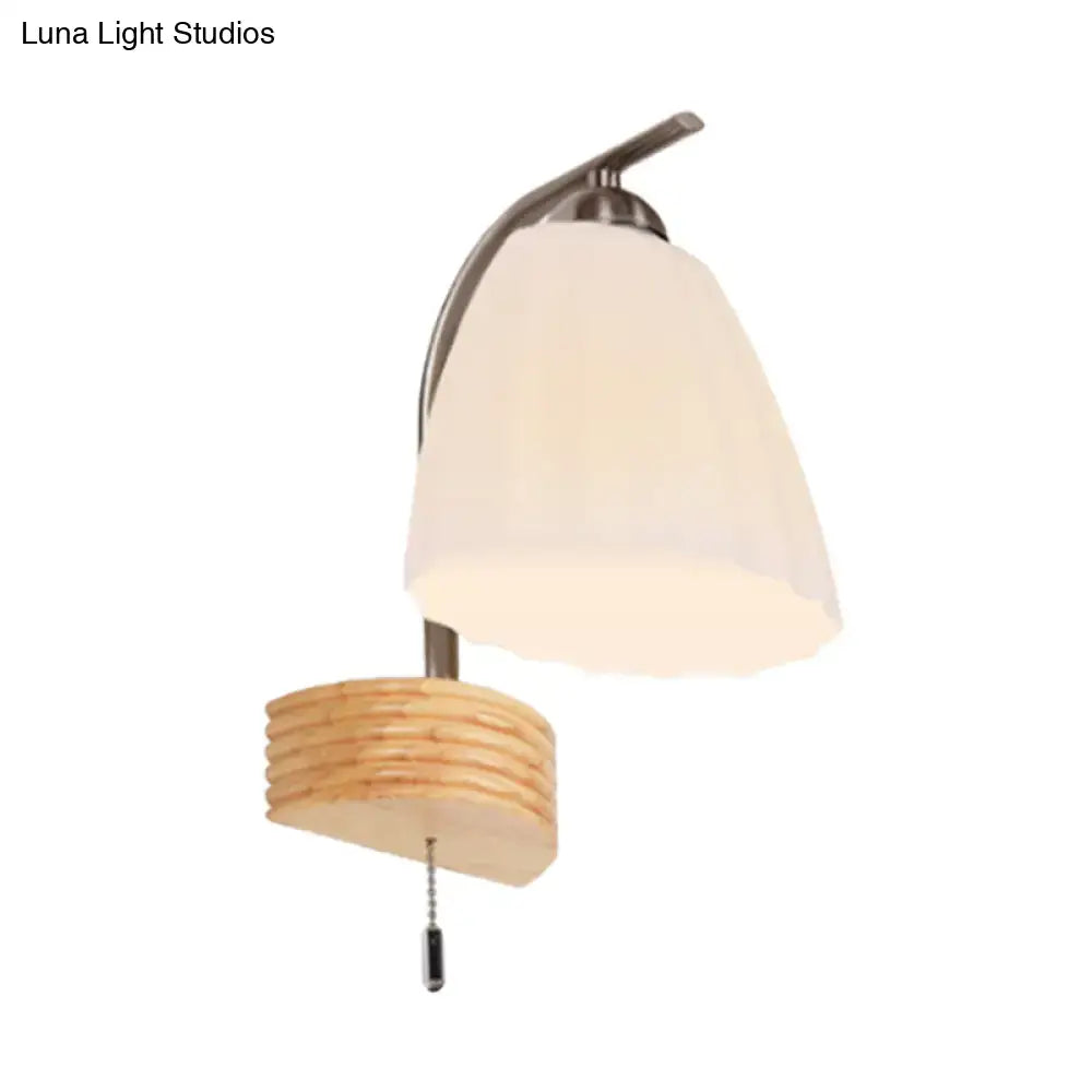 Decorbites ribbed glass wall sconce with curved metal arm and wood ribbed accent pull chain on Tampa Home & Garden Store