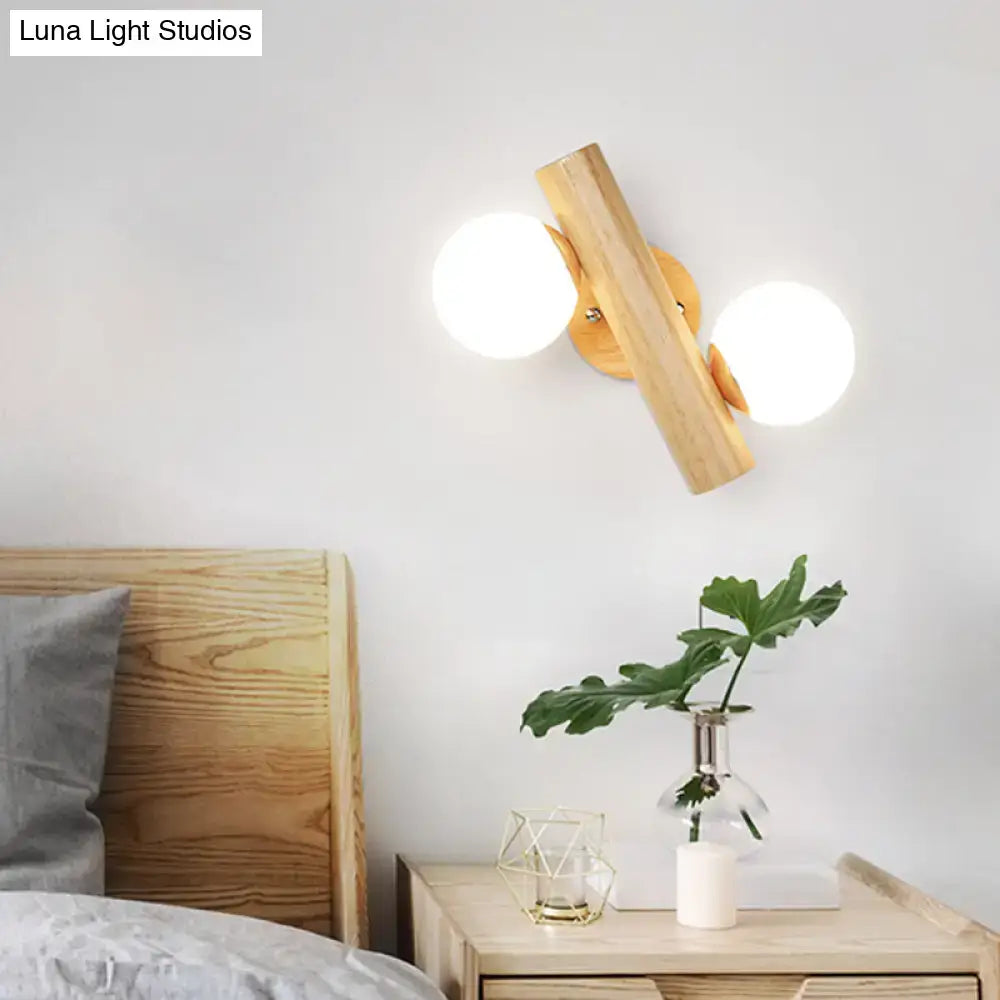 White Glass Ball Sconce by Decorbites with dual illuminated globes on wooden wall mount on Tampa Home & Garden Store