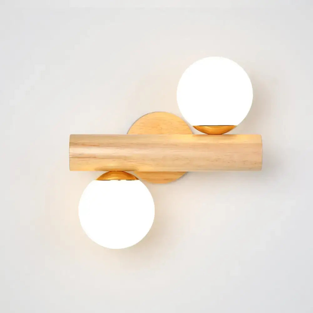 White glass ball sconce on natural wood bar with gold mounts, dual-sphere design on Tampa Home & Garden Store