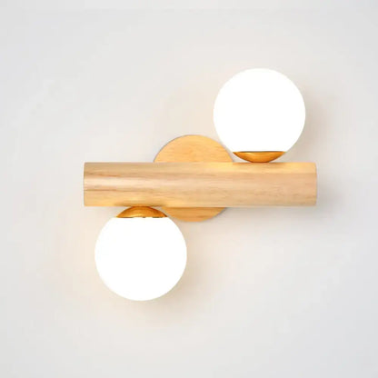 White glass ball sconce on natural wood bar with gold mounts, dual-sphere design on Tampa Home & Garden Store