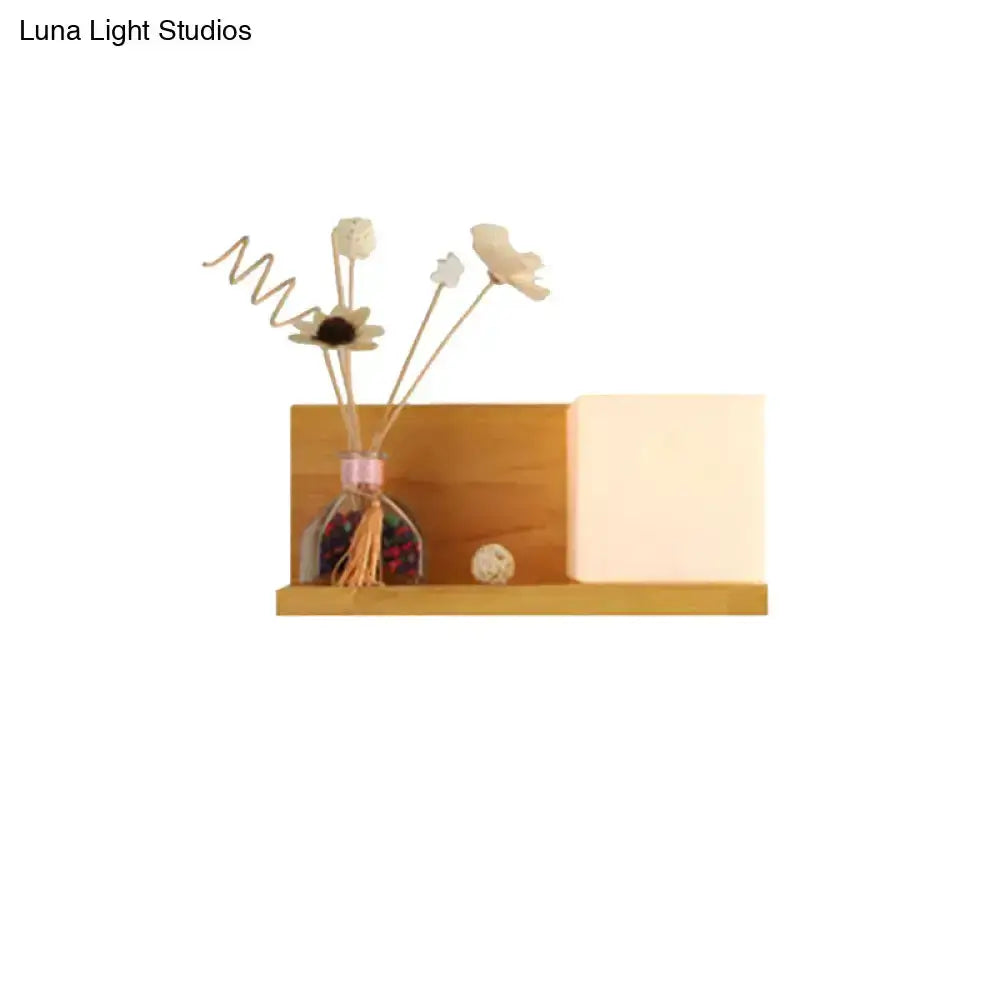 Modern wood floating shelf with beige wall lamp and glass vase of dried flowers on Tampa Home & Garden Store
