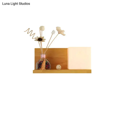 Modern wood floating shelf with beige wall lamp and glass vase of dried flowers on Tampa Home & Garden Store
