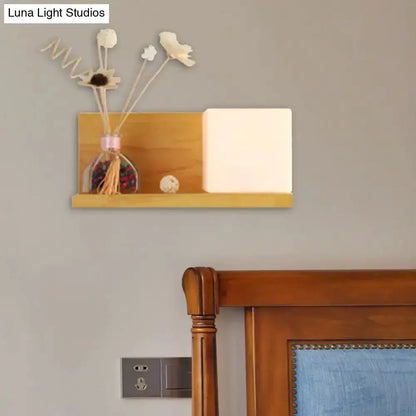 Modern wood floating shelf with beige wall lamp and white shade, bedroom sconce decor on Tampa Home & Garden Store