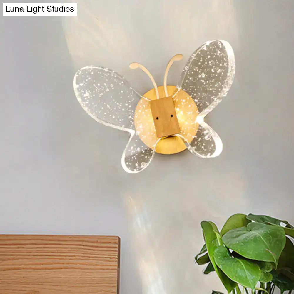 Crystal butterfly wall sconce with speckled white wings and a gold-toned center by Decorbites on Tampa Home & Garden Store
