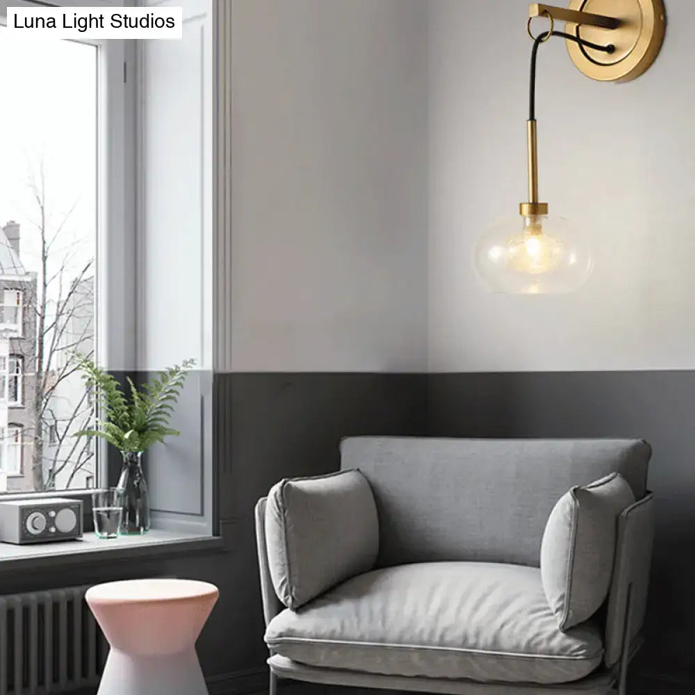 Amber White Glass Sconce by Decorbites with brass mount and amber globe in a gray living room on Tampa Home & Garden Store