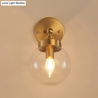 Brass ball rotatable wall lamp with clear glass globe, Luna Light Studios on Tampa Home & Garden Store
