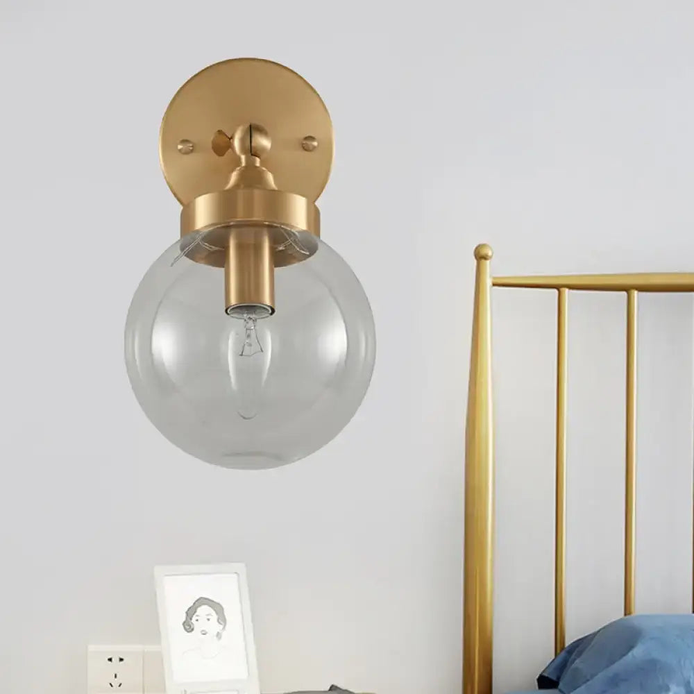 Brass ball rotatable wall lamp by Decorbites with a clear glass globe on Tampa Home & Garden Store