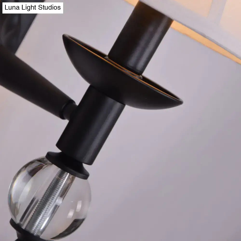 Black metal bell sconce with white fabric shade and clear bulb Luna Light Studios watermark on Tampa Home & Garden Store