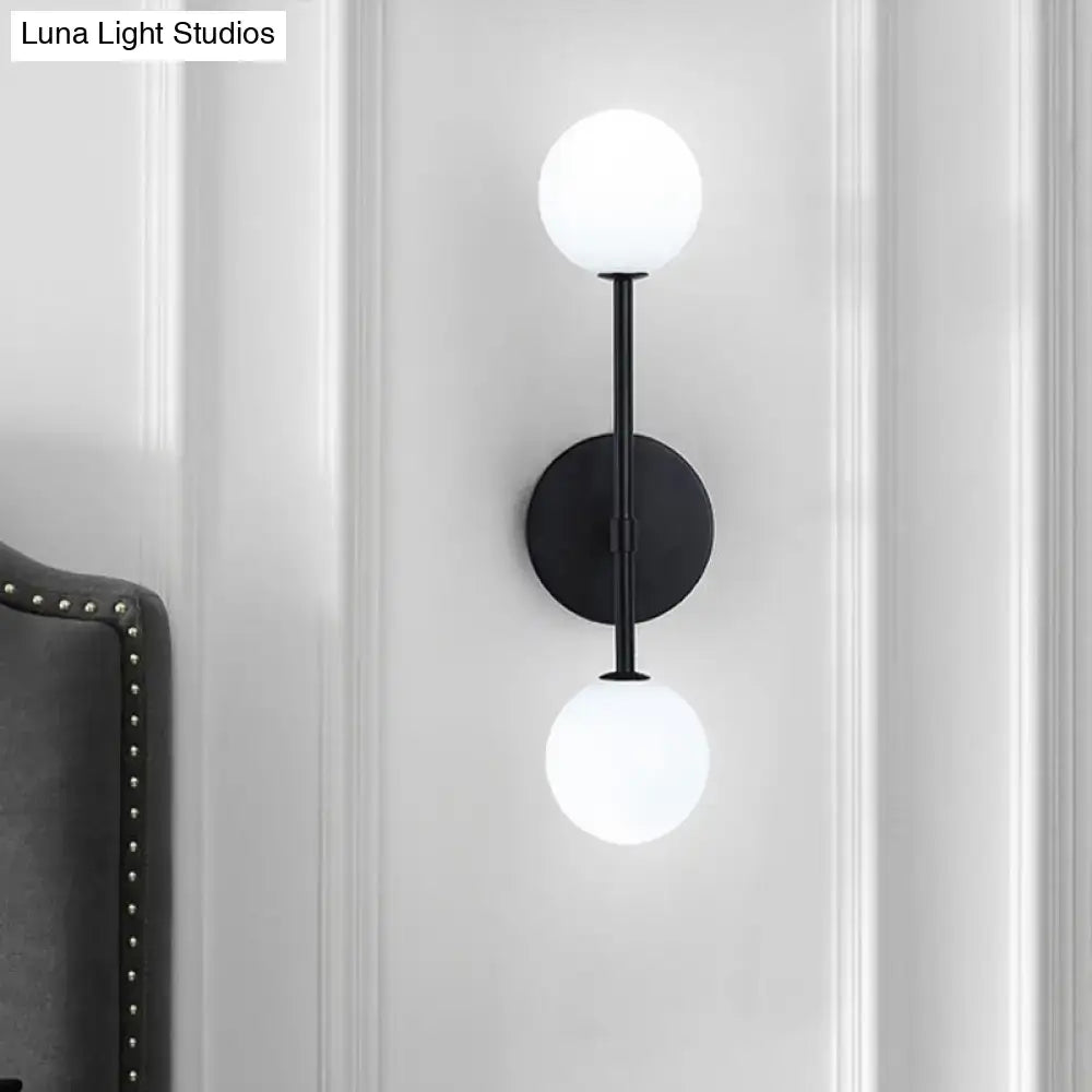 Gold Double Globe Sconce black metal wall mount with two white glass globes by Decorbites on Tampa Home & Garden Store