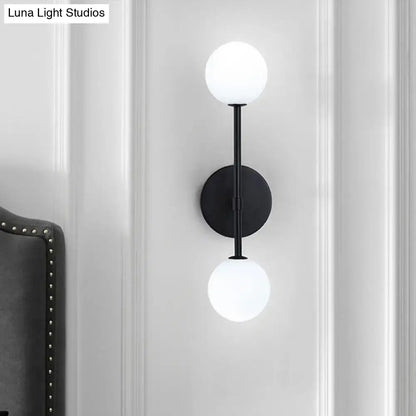 Gold Double Globe Sconce black metal wall mount with two white glass globes by Decorbites on Tampa Home & Garden Store