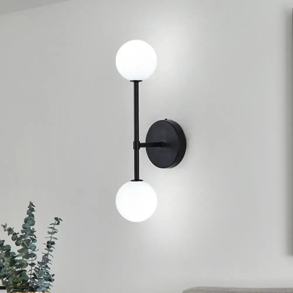 Double Globe Sconce by Decorbites, black metal wall mount with two white glass globes on Tampa Home & Garden Store