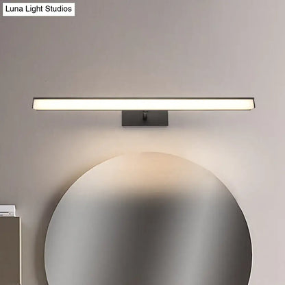 Modernist black and silver metal linear vanity sconce with LED light above a circular mirror on Tampa Home & Garden Store