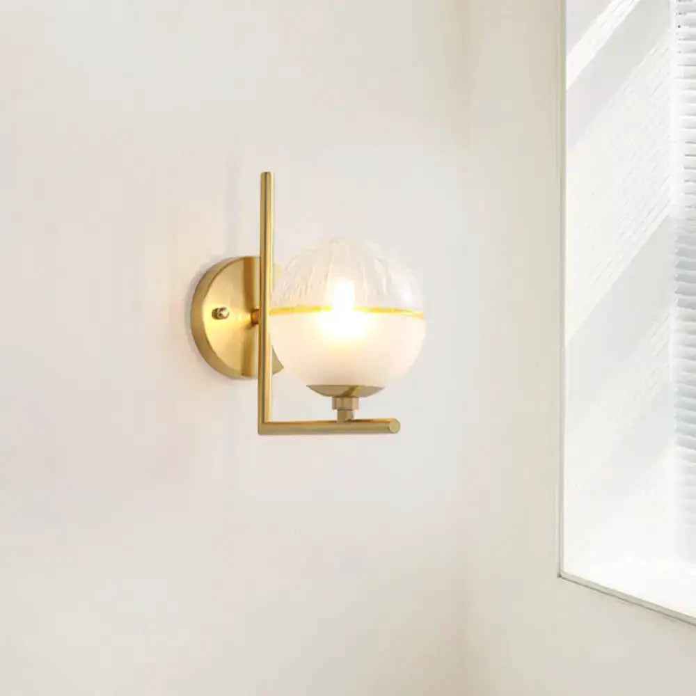 Decorbites modernist brass wall sconce with frosted glass globe on Tampa Home & Garden Store