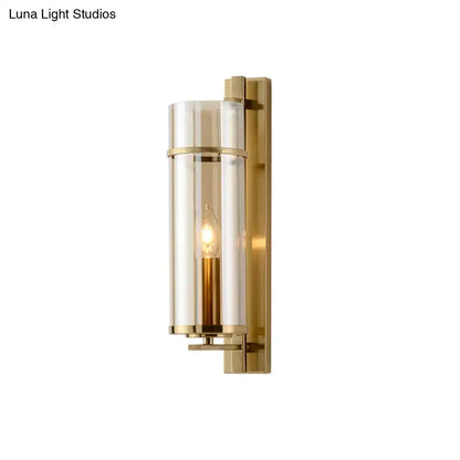 Brass water-blue glass sconce with cylindrical shade and candle-style bulb on Tampa Home & Garden Store