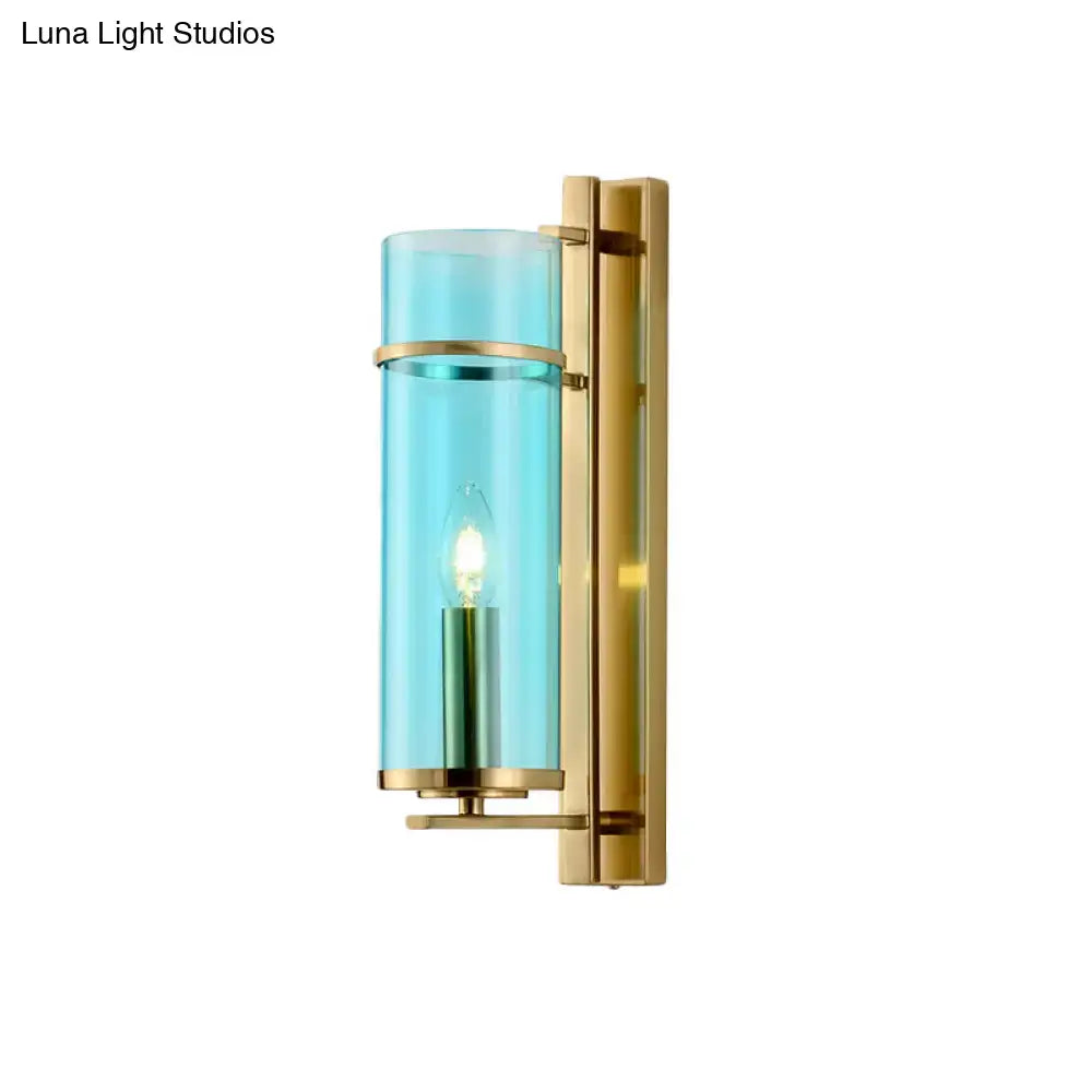 Brass wall sconce with turquoise glass cylinder and exposed bulb by Decorbites on Tampa Home & Garden Store