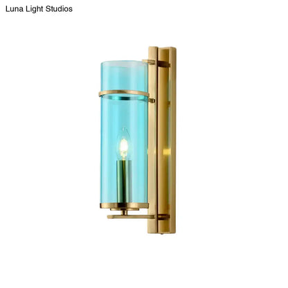 Brass wall sconce with turquoise glass cylinder and exposed bulb by Decorbites on Tampa Home & Garden Store