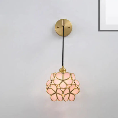 Brass floral glass sconce with pink petal shade and round backplate on black cord on Tampa Home & Garden Store
