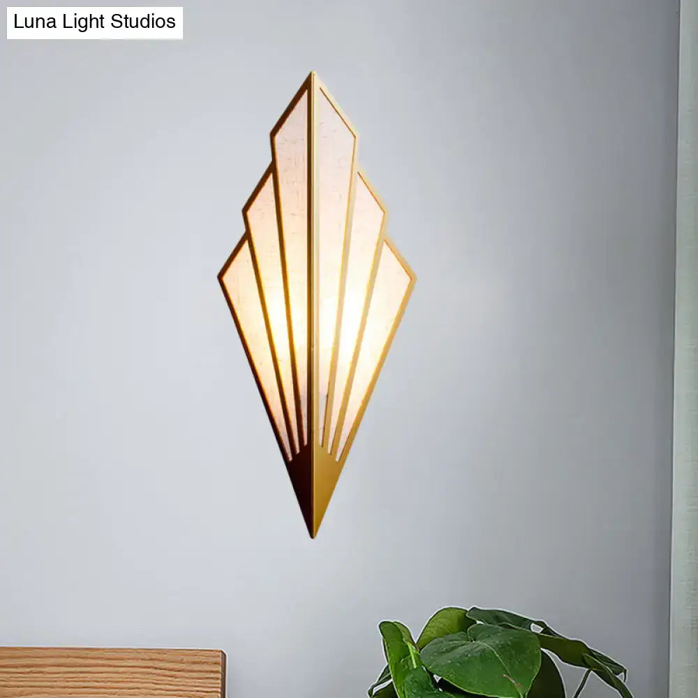 Gold fan wall sconce by Decorbites with geometric sunburst panels and warm glow on gray wall on Tampa Home & Garden Store