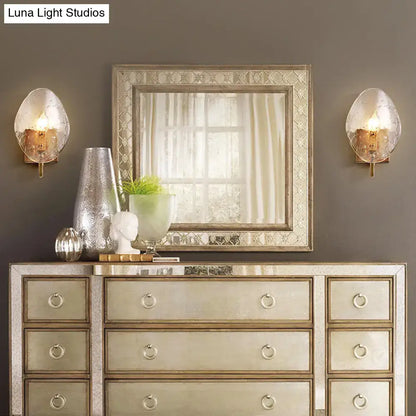 Pair of gold glass shield wall sconces flanking a mirrored dresser Decorbites on Tampa Home & Garden Store