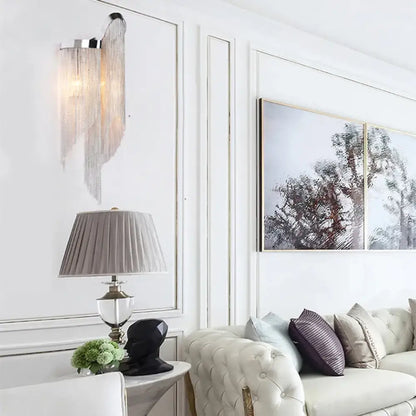 Aluminum tassel wall sconce, two-light gold silver finish by Decorbites mounted on white paneled wall on Tampa Home & Garden Store