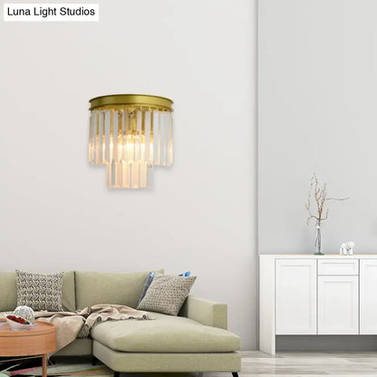 Gold crystal wall lamp faceted two-light with hanging prisms brass finish above beige sofa on Tampa Home & Garden Store