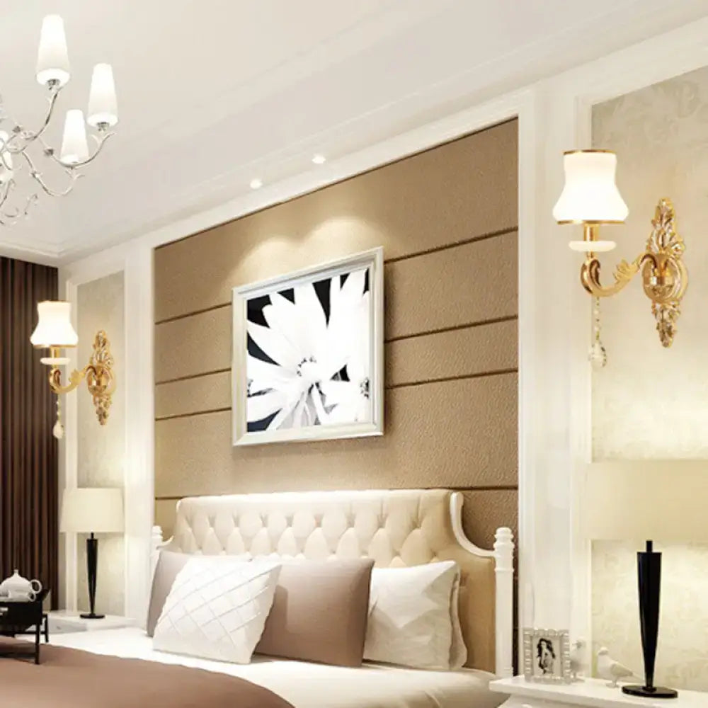 Gold Glass Shade Sconce by Decorbites; brass wall mounts flank a tufted headboard on Tampa Home & Garden Store