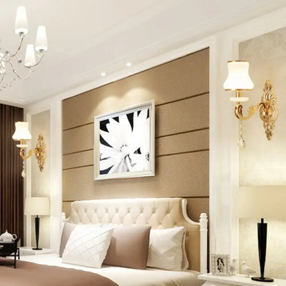 Gold Glass Shade Sconce by Decorbites; brass wall mounts flank a tufted headboard on Tampa Home & Garden Store