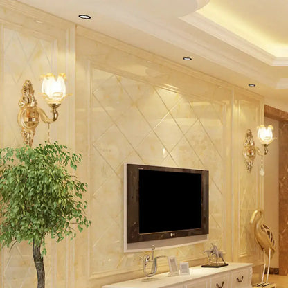 Pair of gold glass shade sconces with gold finish flanking a wall-mounted TV on a marble wall on Tampa Home & Garden Store