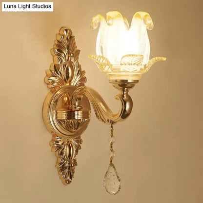 Gold glass shade wall sconce with flower-shaped shade, ornate backplate, crystal teardrop pendant on Tampa Home & Garden Store