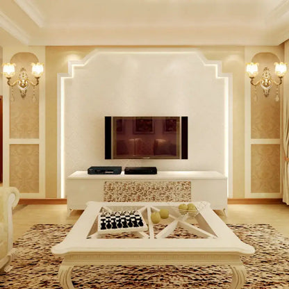 Gold glass shade sconce pair flanking a cream textured wall in a luxurious living room Decorbites on Tampa Home & Garden Store