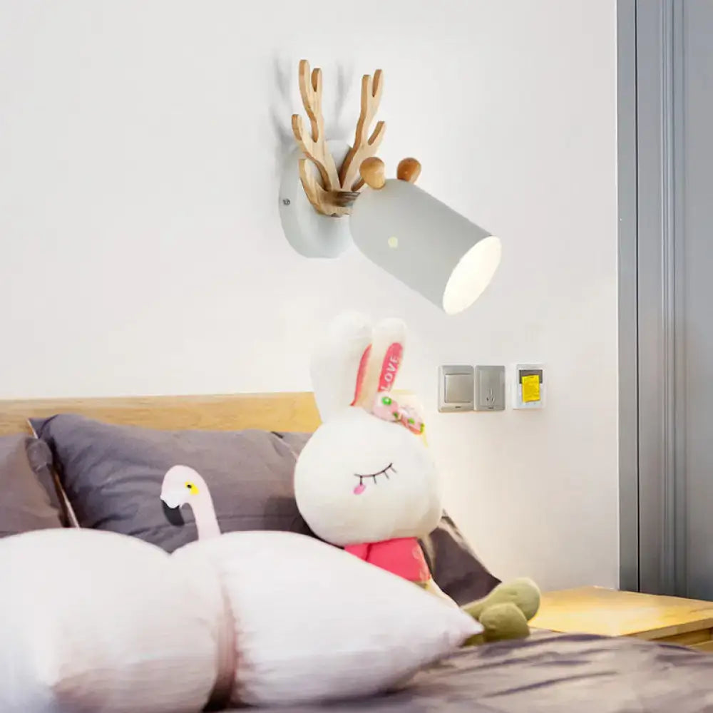 Green wood antler sconce by Decorbites mounted on wall with gray shade on Tampa Home & Garden Store