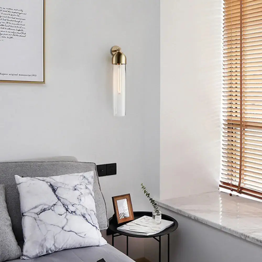 Decorbites metallic tube sconce light with brass finish and glass tube shade, wall mount on Tampa Home & Garden Store
