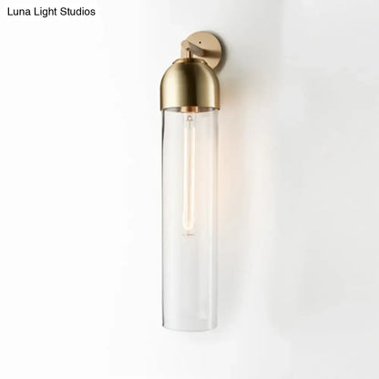 Metallic Tube Sconce Light by Decorbites in gold brass with clear glass tube wall-mounted on Tampa Home & Garden Store