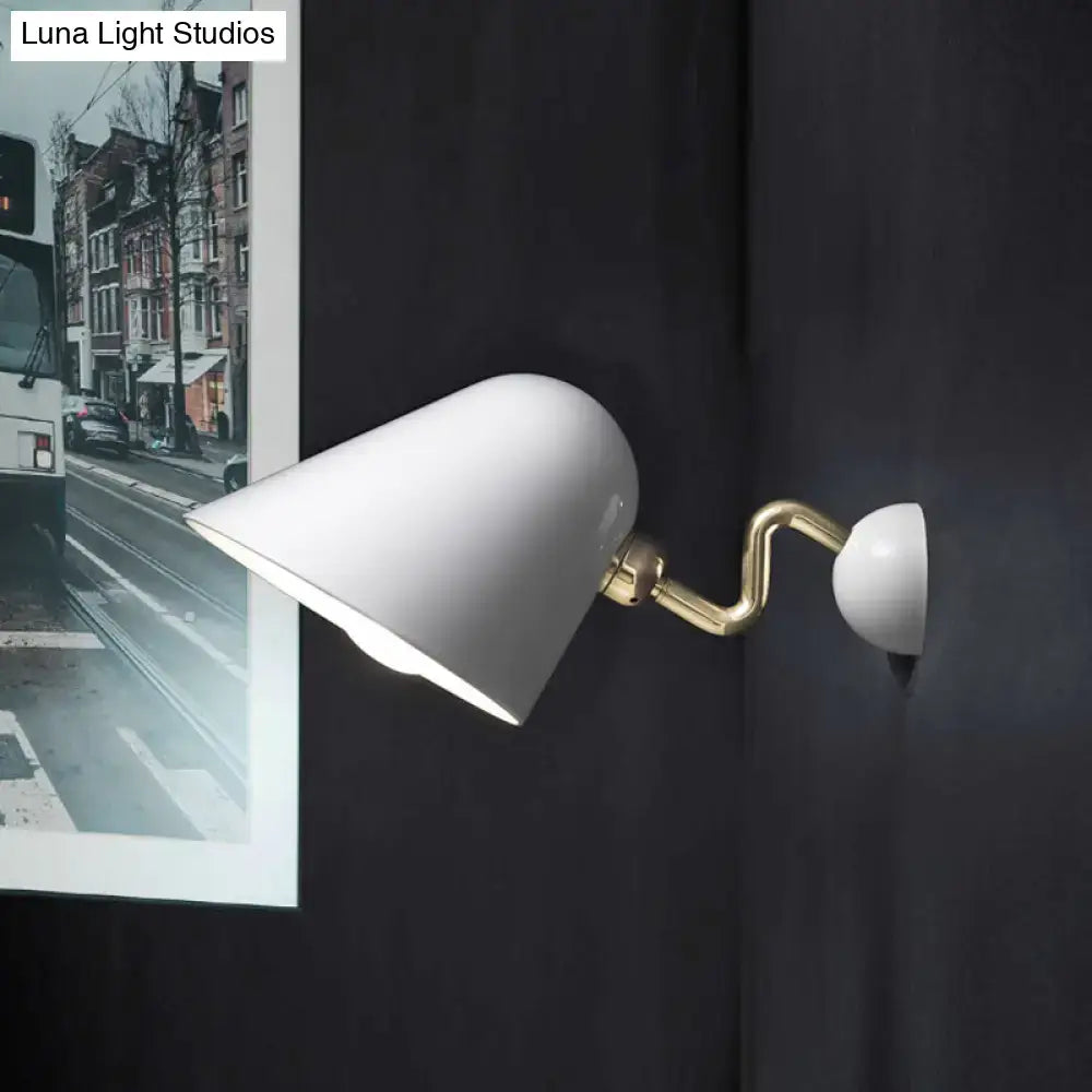 Gold wall sconce light by Decorbites with white shade and brass curved arm mounted on a dark wall on Tampa Home & Garden Store