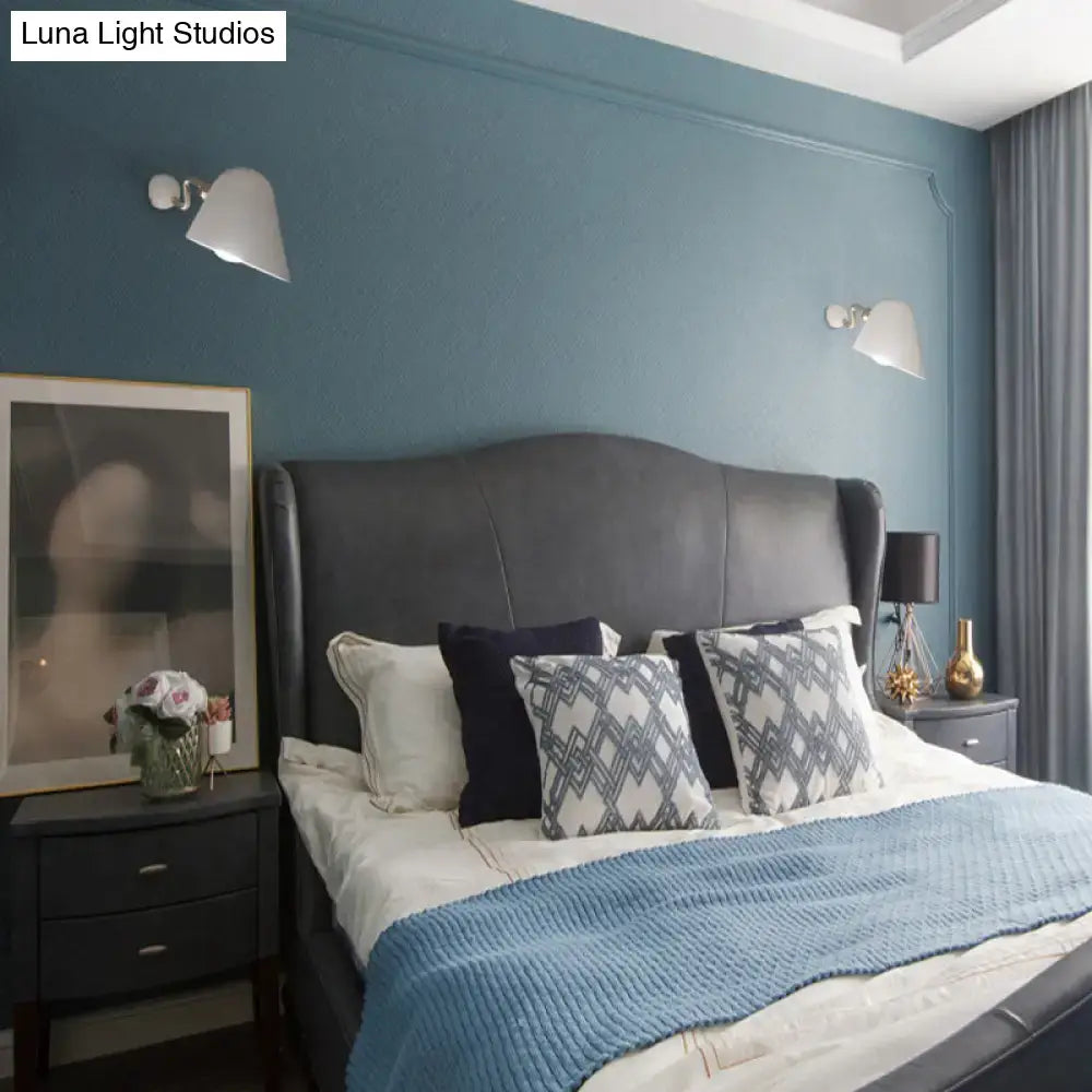 Gold wall sconce light by Decorbites mounted on blue bedroom wall above nightstands on Tampa Home & Garden Store