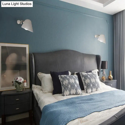 Gold wall sconce light by Decorbites mounted on blue bedroom wall above nightstands on Tampa Home & Garden Store