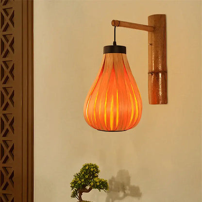Bamboo Slat Wall Lantern by Decorbites, warm amber glow, wall-mounted on copper bracket on Tampa Home & Garden Store