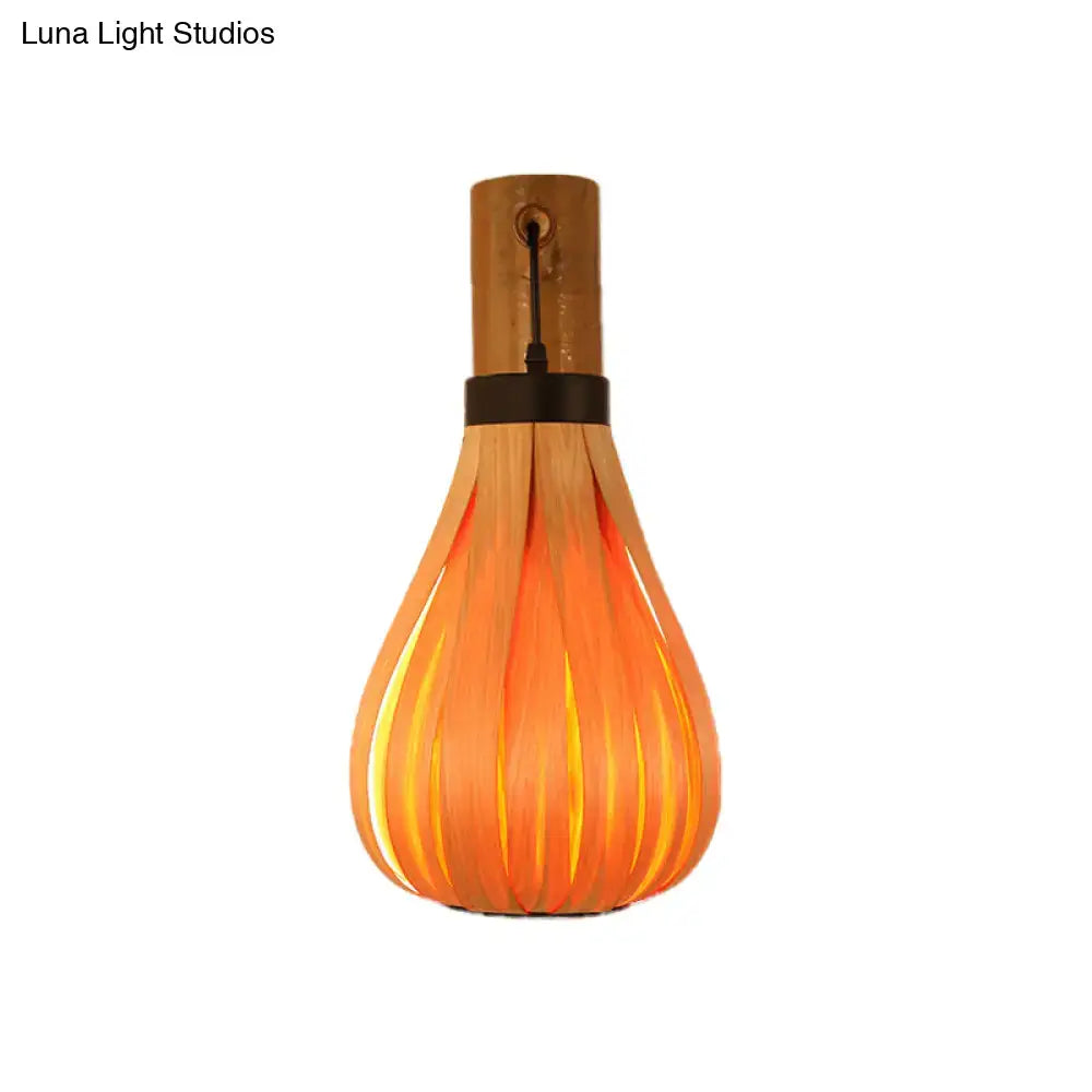 Bamboo slat wall lantern with curved slats forming a teardrop silhouette, warm amber on Tampa Home & Garden Store