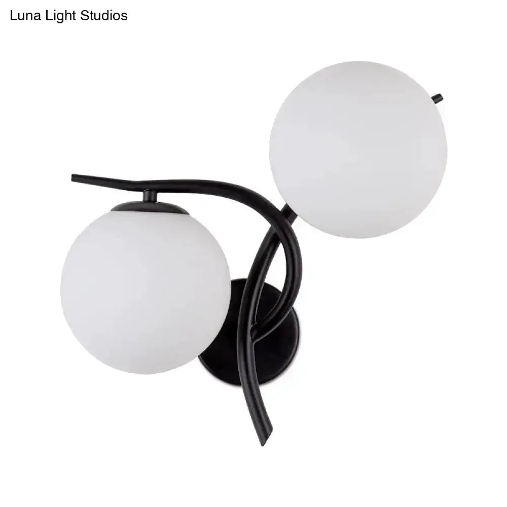 Two-light wall sconce by Decorbites with black metal arms and milky glass globes for bedroom on Tampa Home & Garden Store