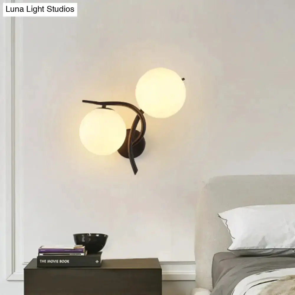 Decorbites modernist silver and black wall sconce with two milky glass globes for bedroom on Tampa Home & Garden Store