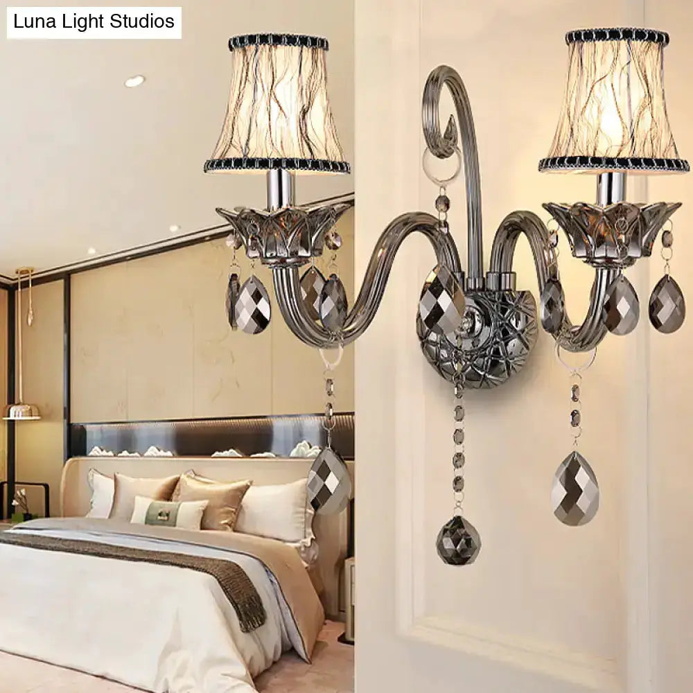 Modernist smoke grey crystal wall sconce with dual curved arms and hanging prisms on Tampa Home & Garden Store