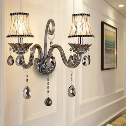 Modernist smoke grey crystal wall sconce with dual arms and hanging teardrop crystals Decorbites on Tampa Home & Garden Store