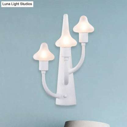 White ceramic glass sconce by Decorbites with three mushroom-shaped bulbs on wall on Tampa Home & Garden Store