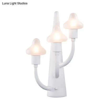 White ceramic glass three-arm sconce with three mushroom-shaped frosted bulbs on Tampa Home & Garden Store