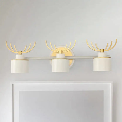 White Gold Antler Sconce trio with cylinder shades and gold antler accents by Decorbites on Tampa Home & Garden Store