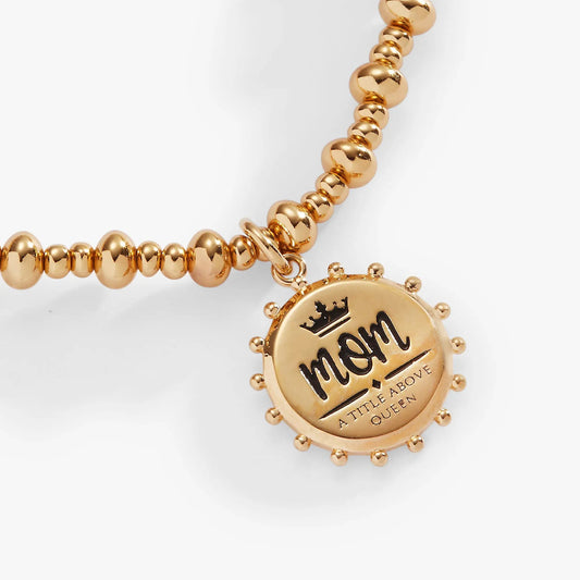 Gold-tone beaded stretch bracelet with circular charm engraved Mom A Title Above Queen on Tampa Home & Garden Store