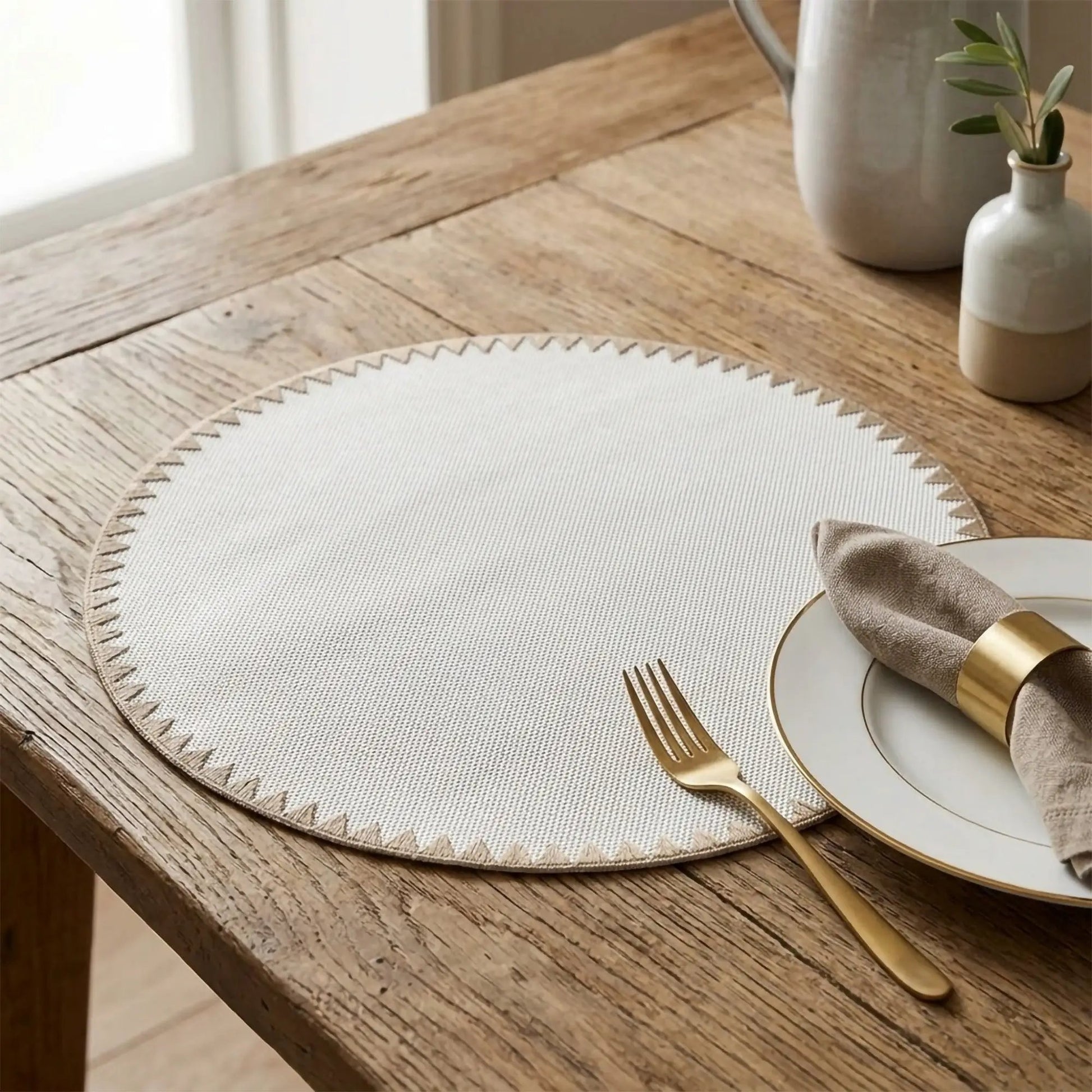 Montana Placemat With Bold Geometric Trim, light beige woven texture on a rustic wood table on Tampa Home & Garden Store