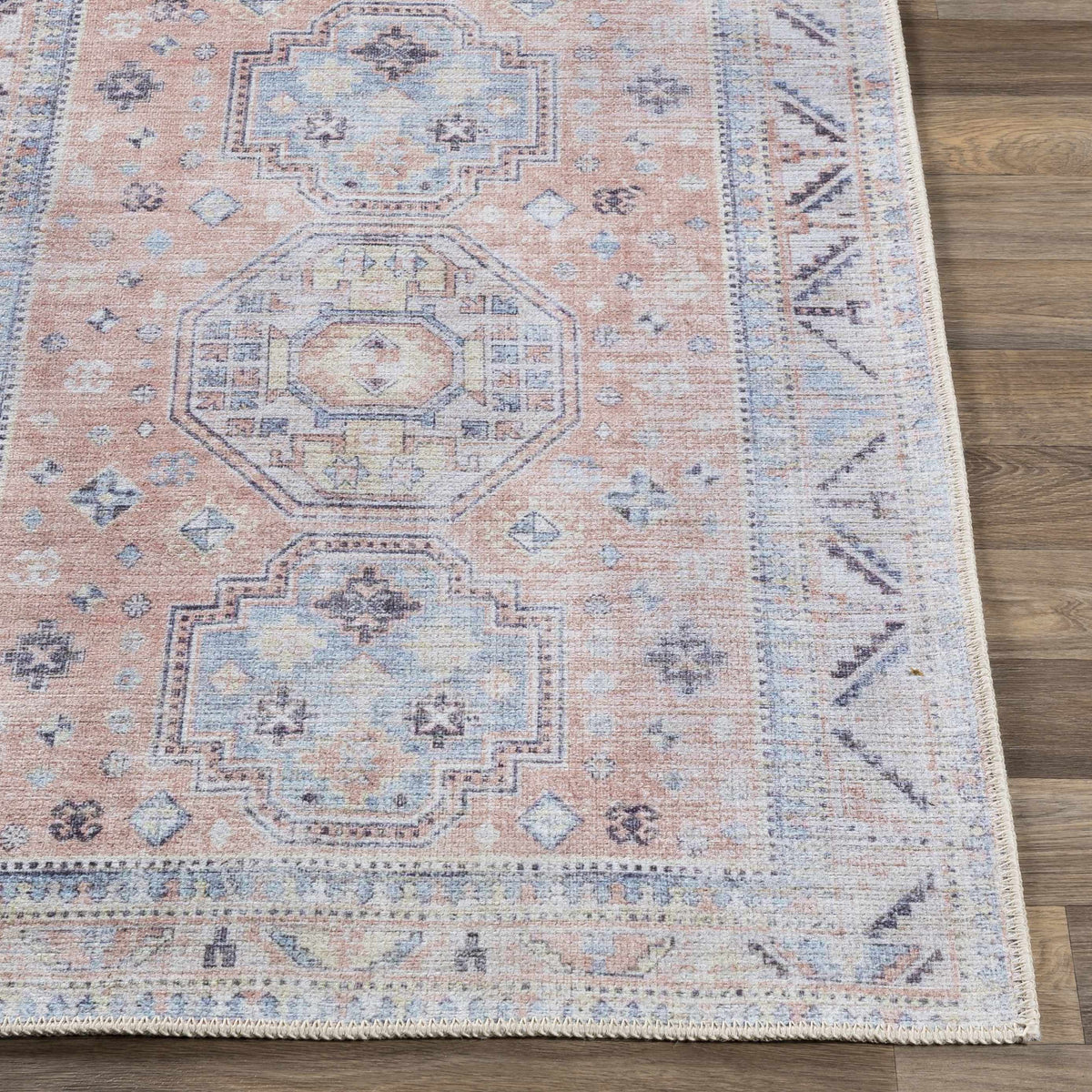 Morcott Peach Washable Area Rug peach-blue medallion fringe on wood floor on Tampa Home & Garden Store
